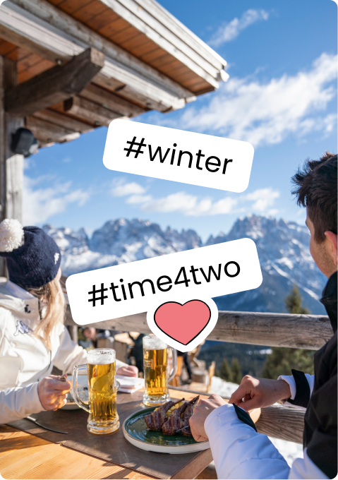 Two people on mountain terrace sharing beer and meat with snowy peaks in background, stickers #winter #time4two